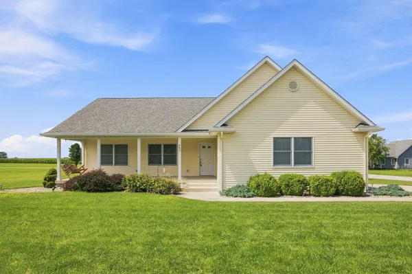 a front view of house with yard and green space