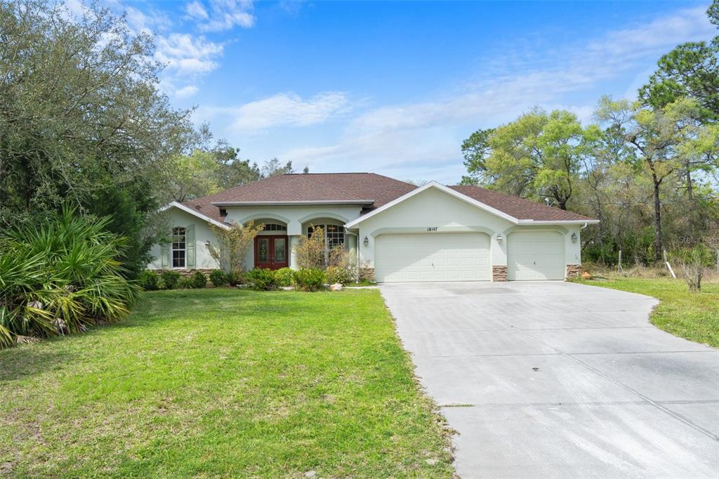 18147 Parakeet Road Weeki Wachee, FL 34614 - Photo 1 of 1 a front view of a house with garden