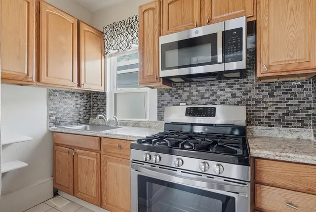 a stove top oven sitting inside of a kitchen