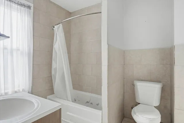 a bathroom with a toilet and a bathtub