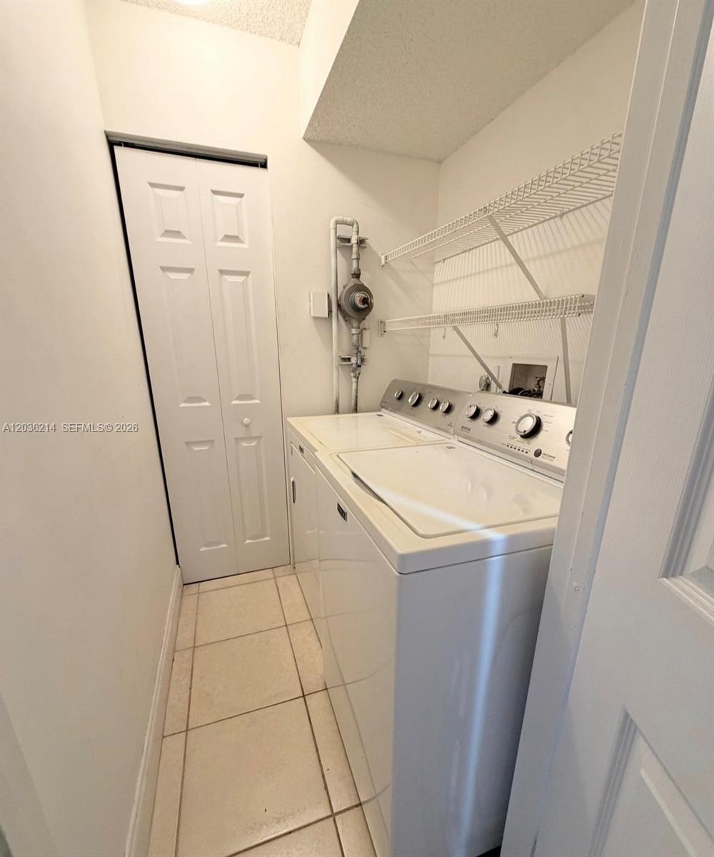 8741 Wiles Road, Unit 204 Coral Springs, FL 33067 - Photo 16 of 16 a utility room with dryer and washer
