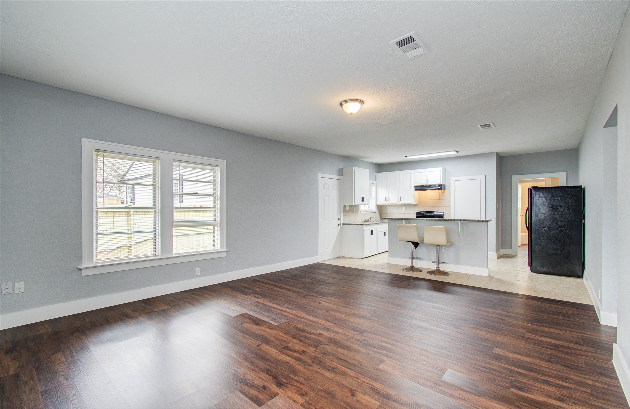 3824 Topping Street Houston, TX 77093 - Photo 14 of 31 a living room with furniture and a dining table with wooden floor
