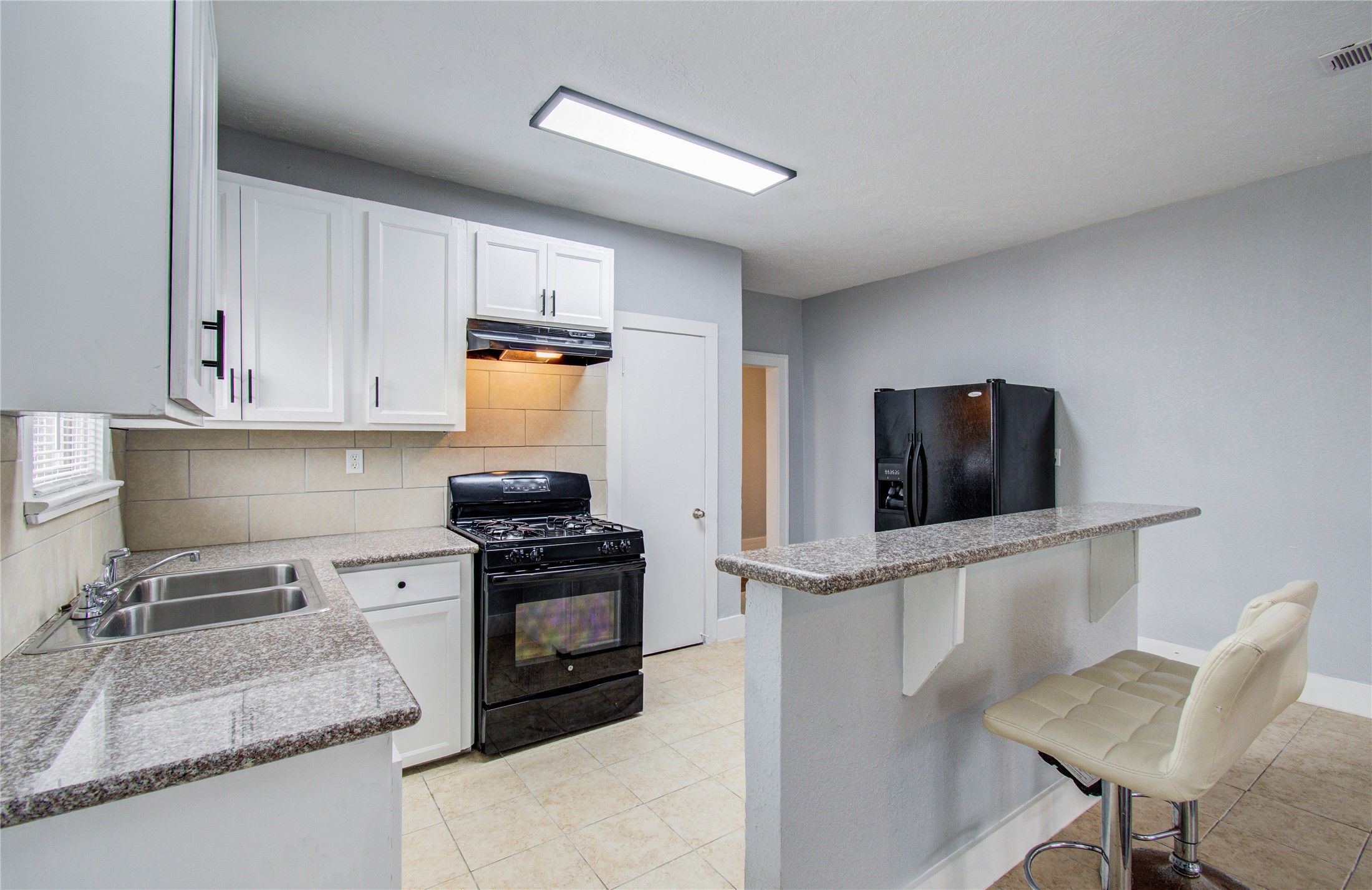 3824 Topping Street Houston, TX 77093 - Photo 16 of 31 a kitchen with granite countertop a stove and a sink