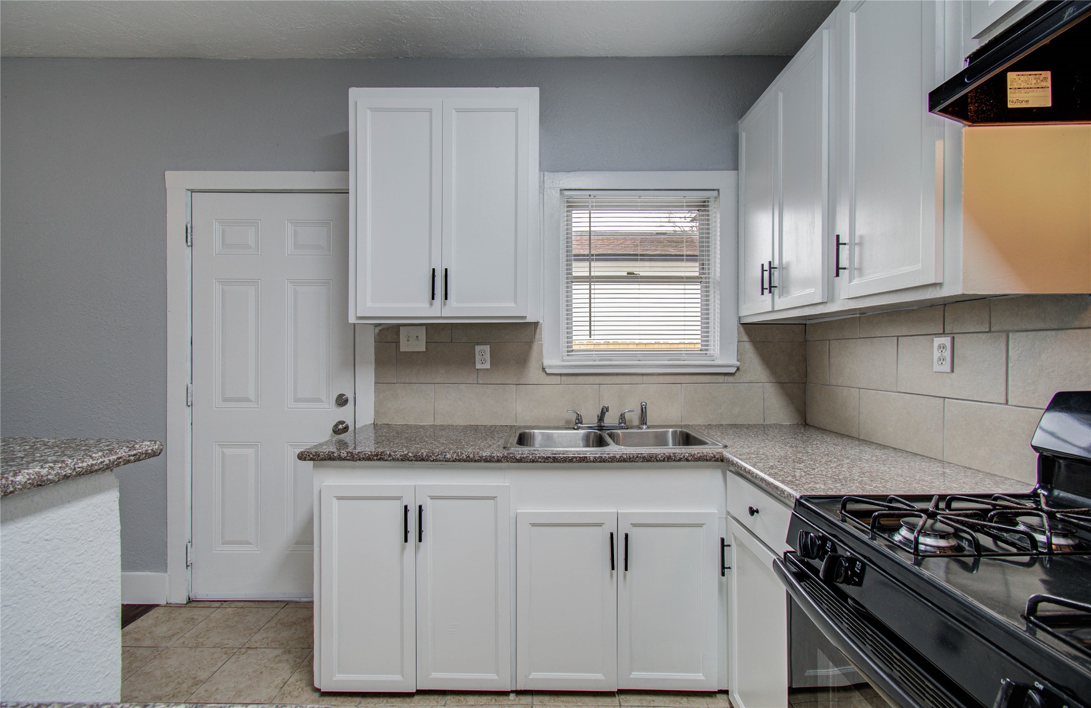 3824 Topping Street Houston, TX 77093 - Photo 18 of 31 a kitchen with granite countertop white cabinets and white appliances