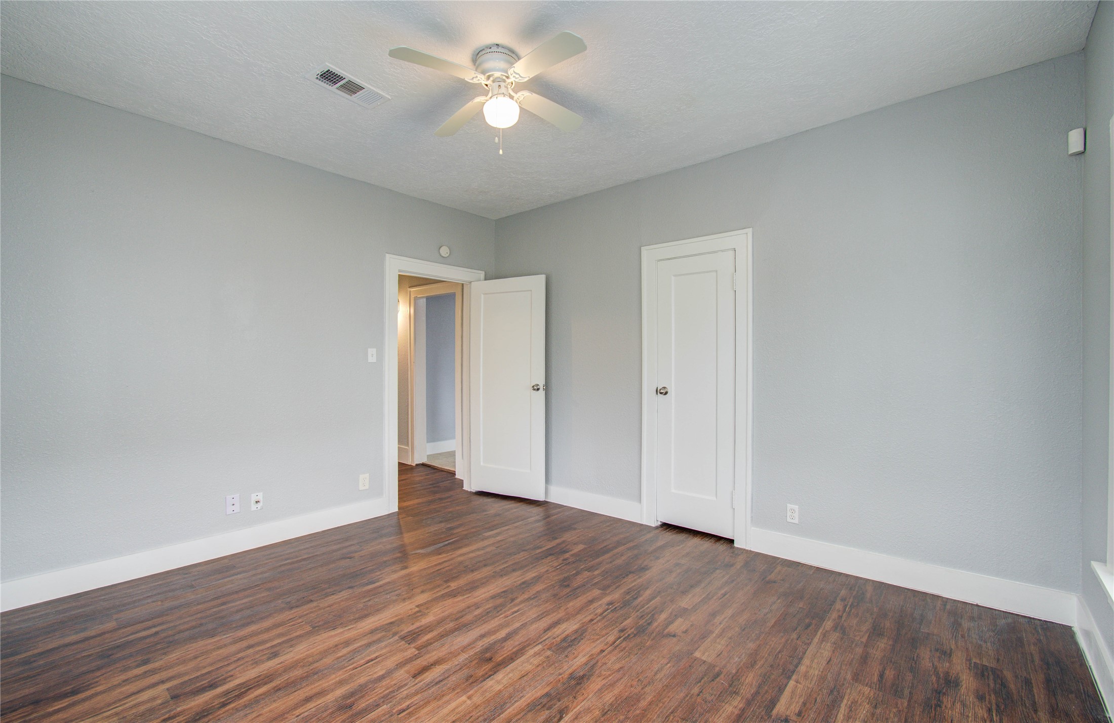 3824 Topping Street Houston, TX 77093 - Photo 20 of 31 an empty room with wooden floor and ceiling fan