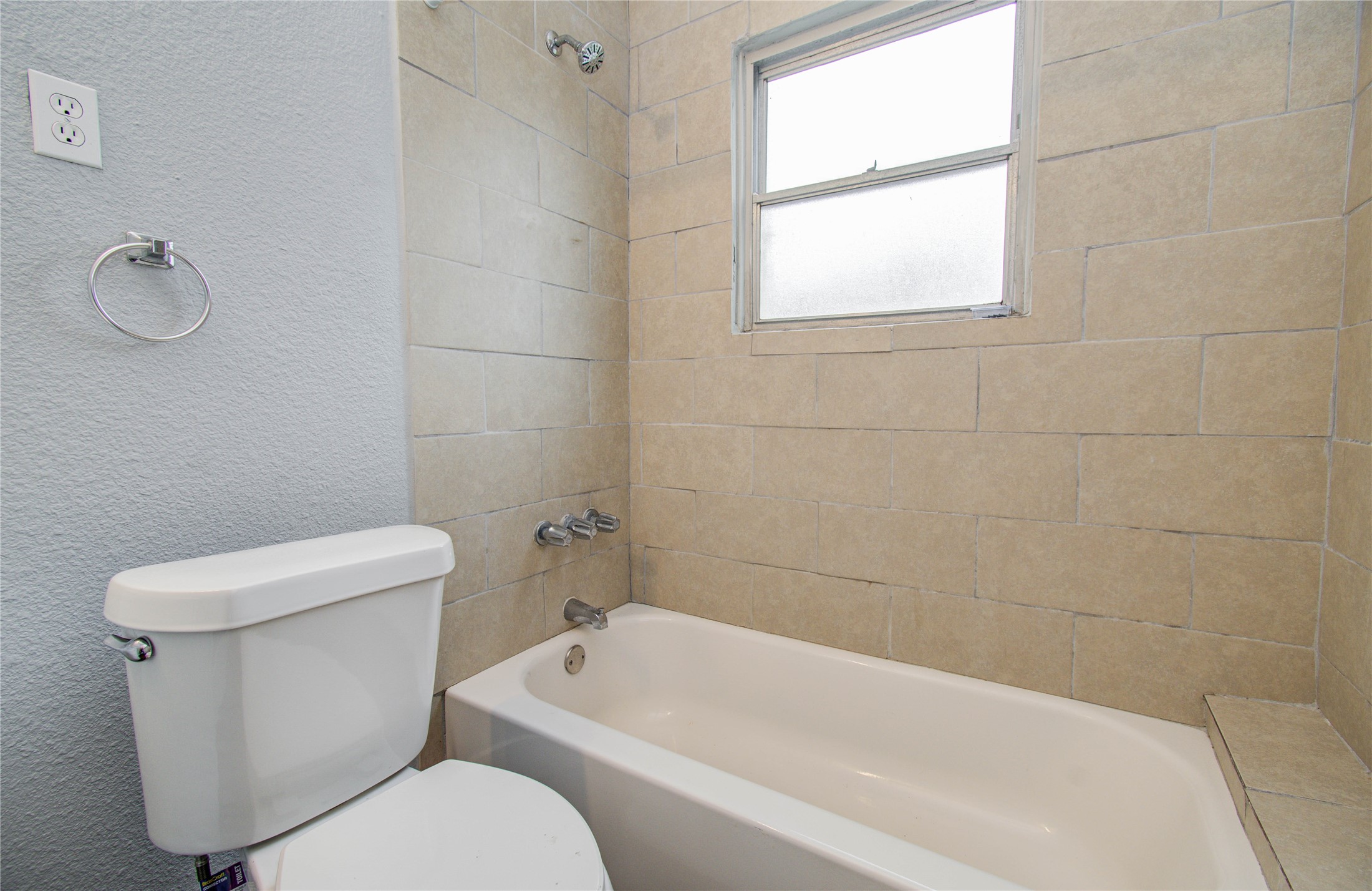 3824 Topping Street Houston, TX 77093 - Photo 25 of 31 a white toilet and tub sitting next to a window