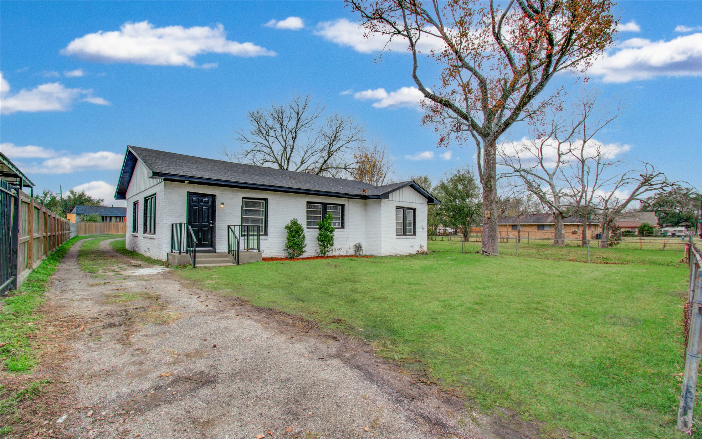 3824 Topping Street Houston, TX 77093 - Photo 5 of 31 a front view of a house with a garden and trees
