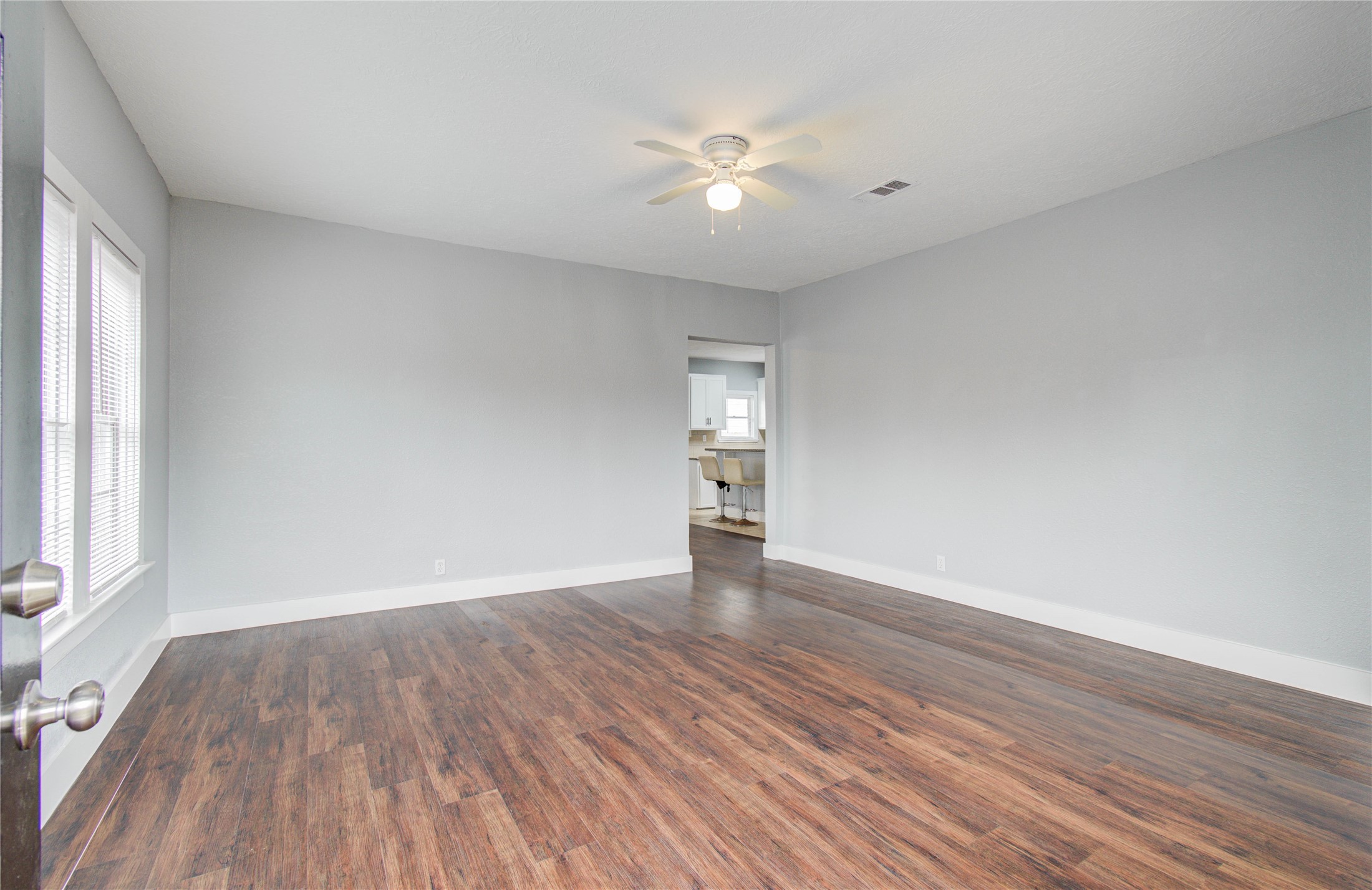 3824 Topping Street Houston, TX 77093 - Photo 7 of 31 a view of an empty room with wooden floor and a window