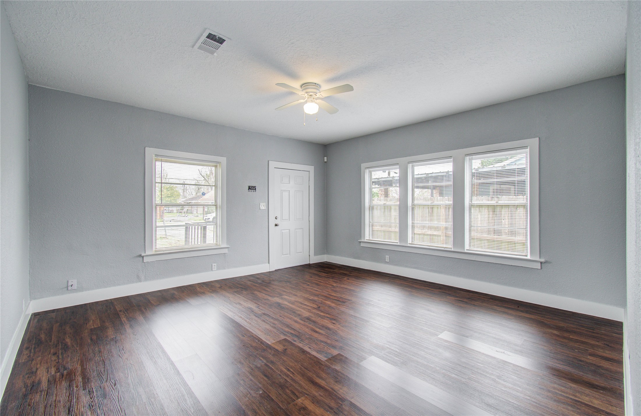 3824 Topping Street Houston, TX 77093 - Photo 9 of 31 a view of an empty room with wooden floor and a window