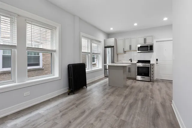 a view of kitchen with cabinets and wooden floor