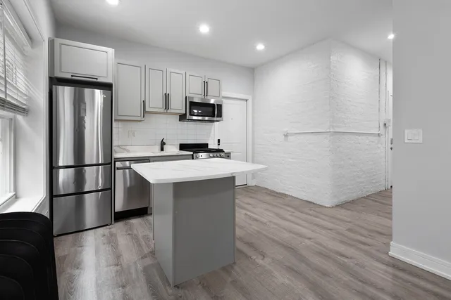 a kitchen with stainless steel appliances a refrigerator stove microwave and sink