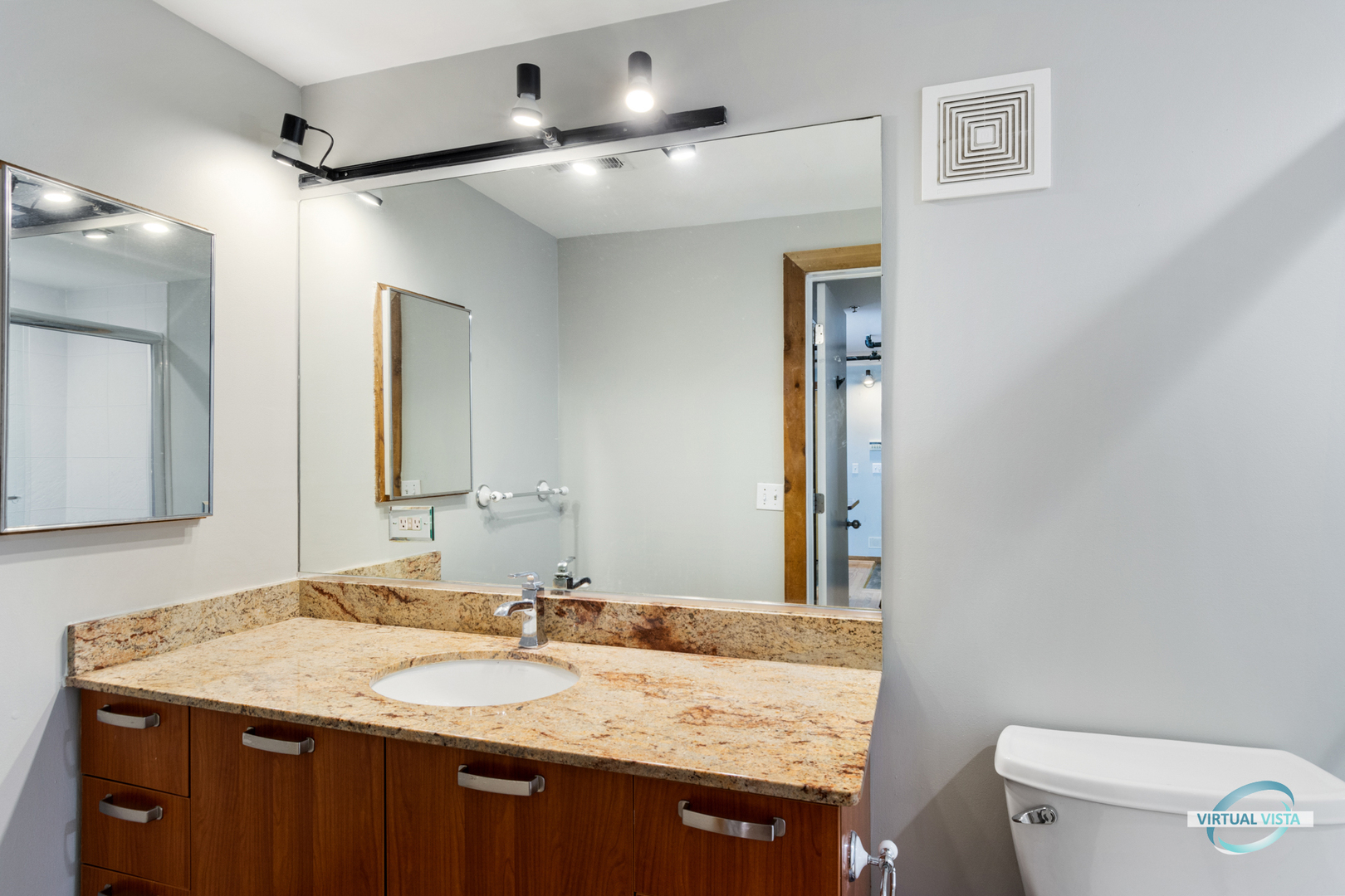 732 South Financial Place, Unit 104 Chicago, IL 60605 - Photo 14 of 30 a bathroom with a granite countertop sink a toilet and a mirror