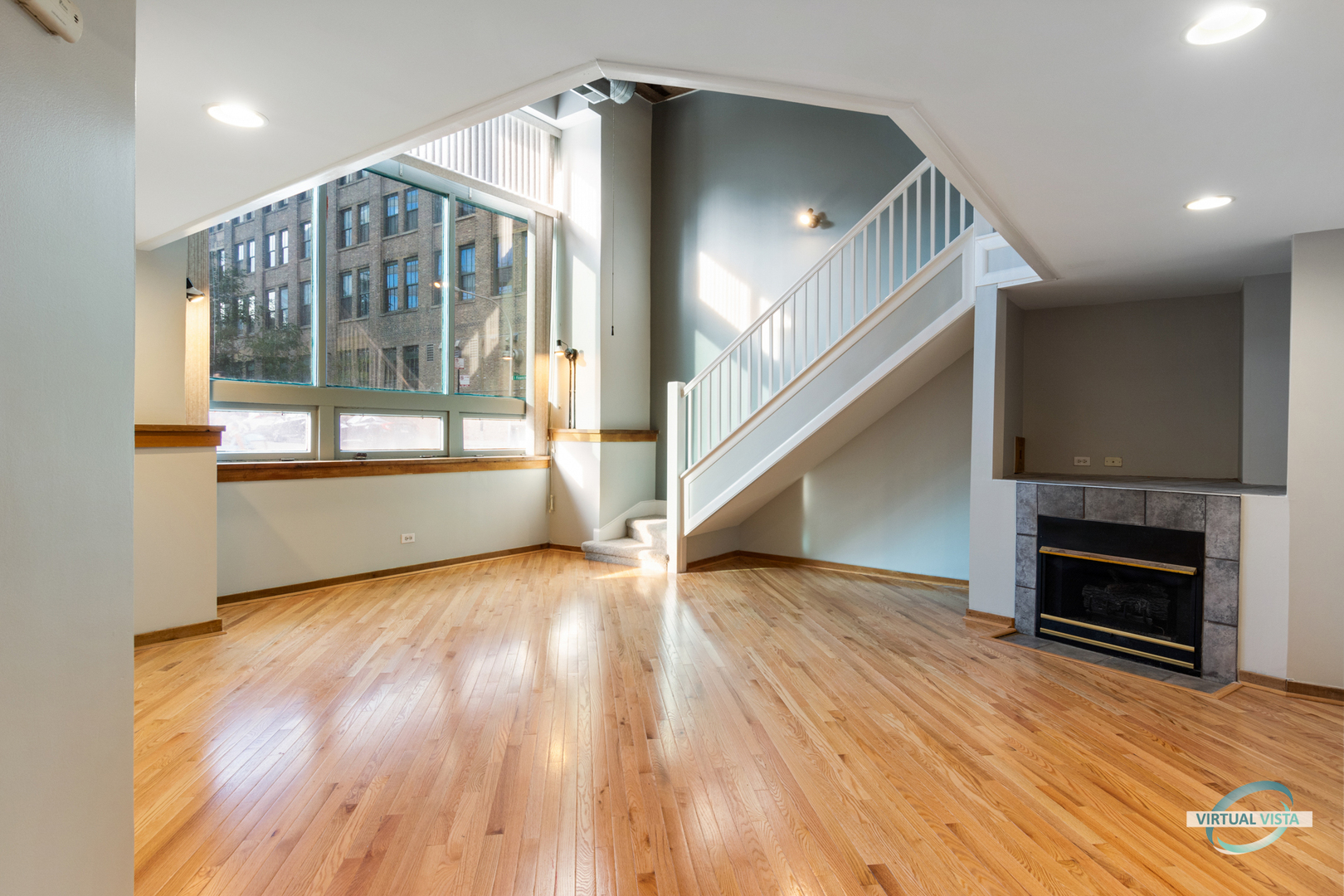 732 South Financial Place, Unit 104 Chicago, IL 60605 - Photo 4 of 30 a view of empty room with wooden floor and fireplace