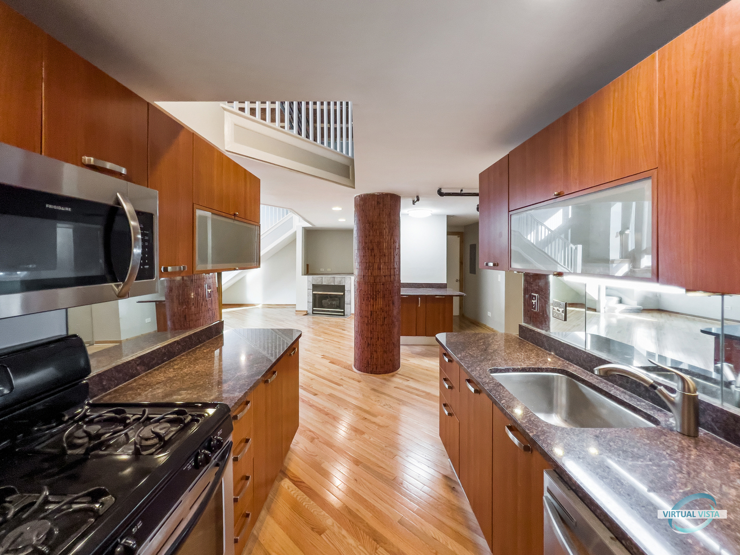 732 South Financial Place, Unit 104 Chicago, IL 60605 - Photo 5 of 30 a kitchen with stainless steel appliances kitchen island granite countertop a sink and a stove