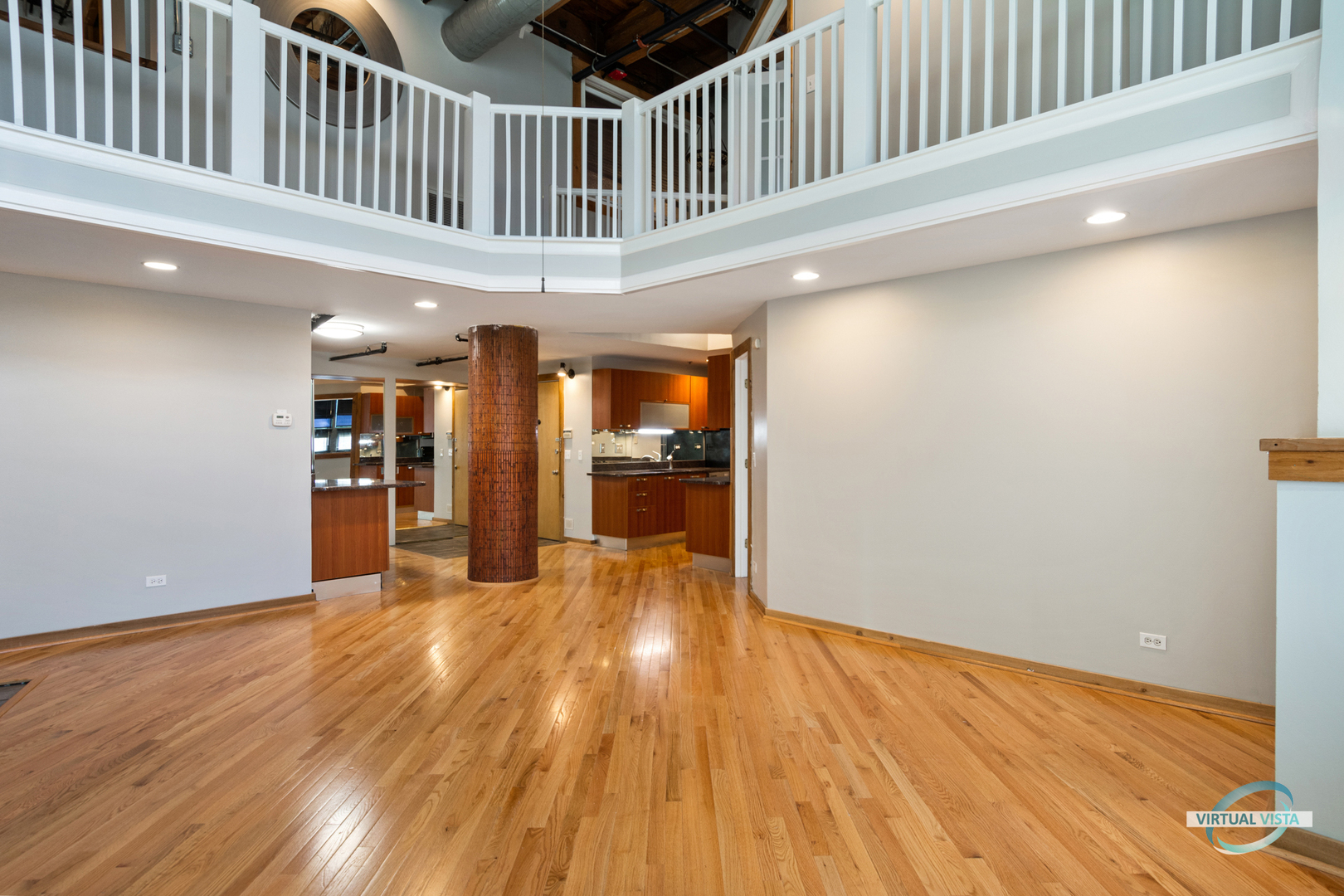 732 South Financial Place, Unit 104 Chicago, IL 60605 - Photo 6 of 30 a view of a hallway with wooden floor and a kitchen