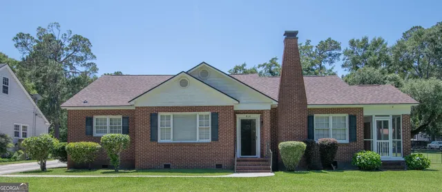 a front view of a house with garden