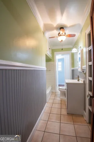 a view of a kitchen with a refrigerator and a sink