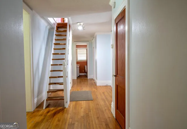 a view of a room with stairs and wooden floor