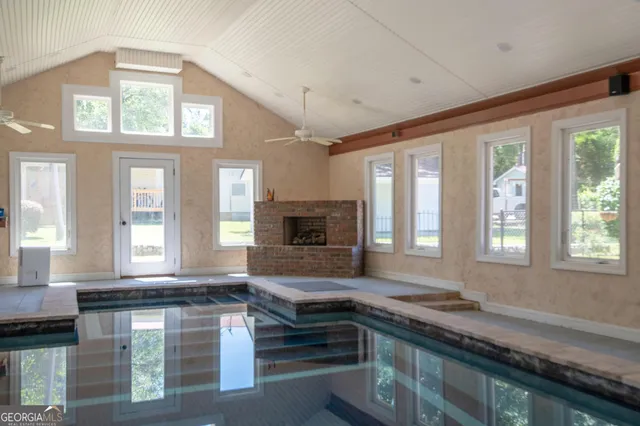 a large kitchen with a large window and stainless steel appliances