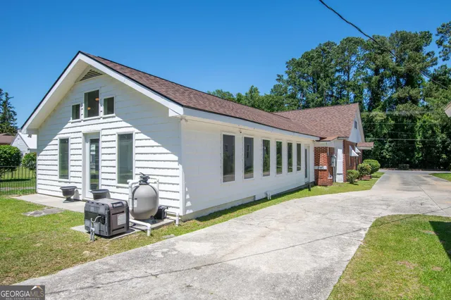 a view of a house with a yard and a garden