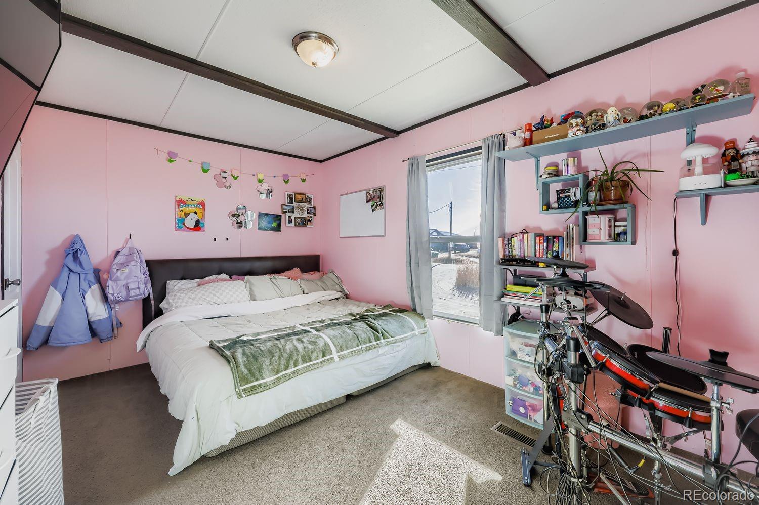 27604 Mucho Grande View Road Calhan, CO 80808 - Photo 11 of 16 a bed room with a bed and a desk