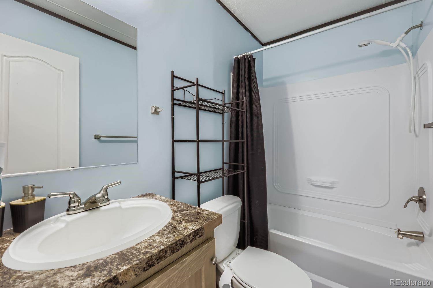 27604 Mucho Grande View Road Calhan, CO 80808 - Photo 12 of 16 a bathroom with a granite countertop sink toilet and shower