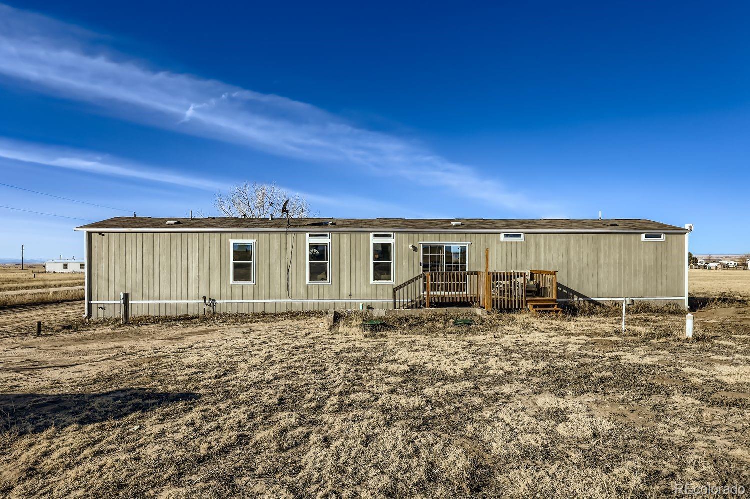 27604 Mucho Grande View Road Calhan, CO 80808 - Photo 2 of 16 a backyard of a house with yard and outdoor seating