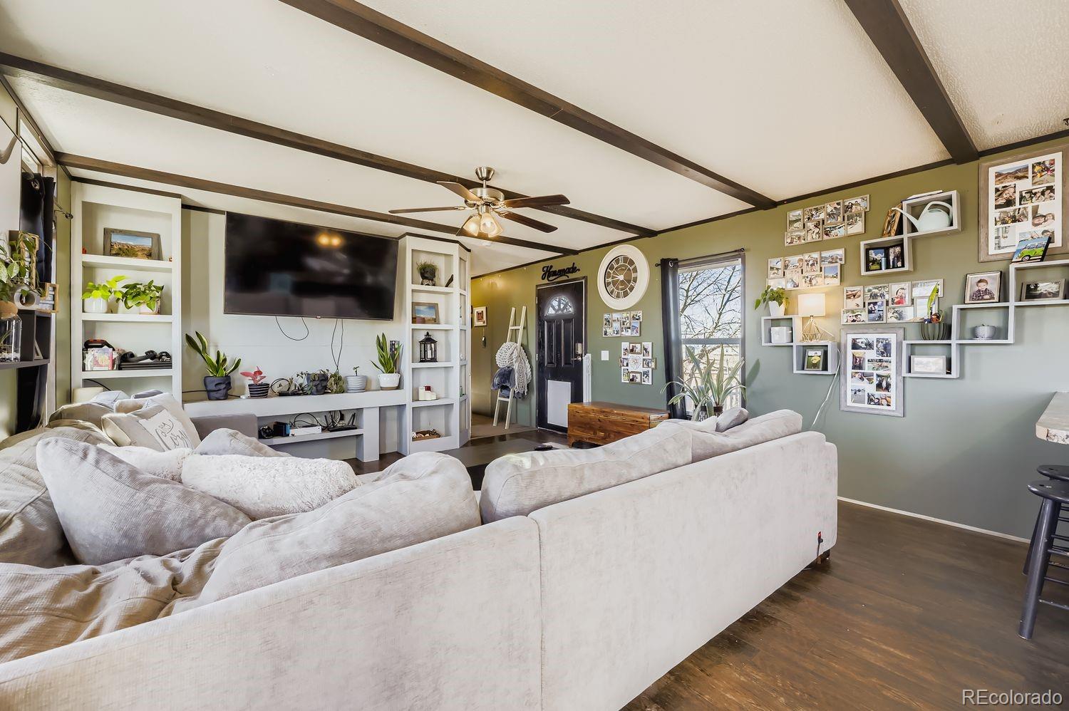 27604 Mucho Grande View Road Calhan, CO 80808 - Photo 3 of 16 a living room with furniture and a flat screen tv