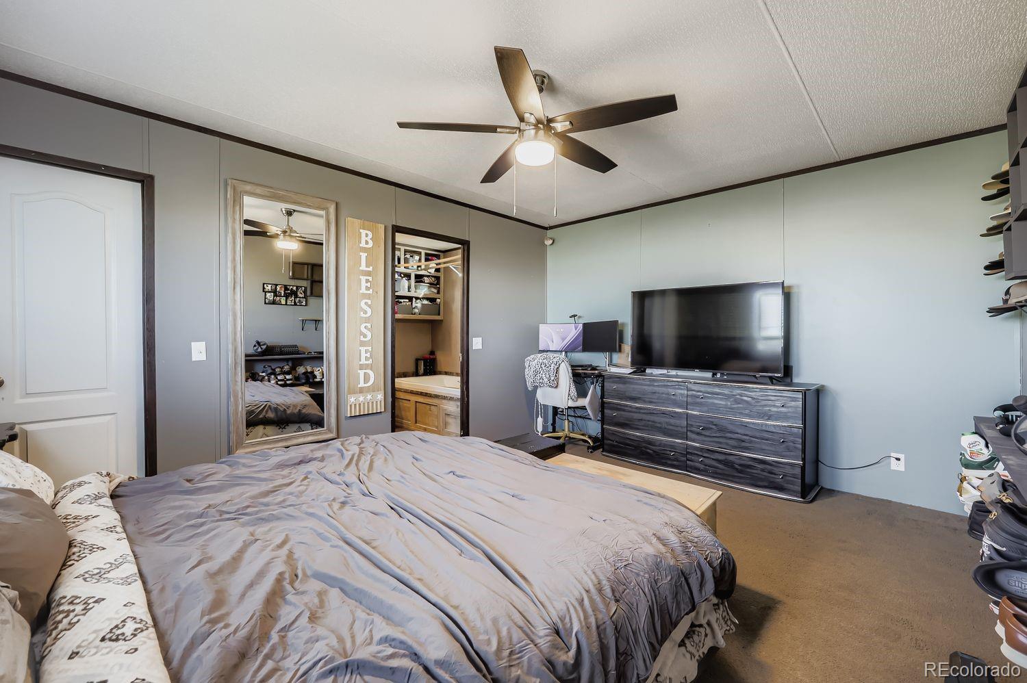 27604 Mucho Grande View Road Calhan, CO 80808 - Photo 7 of 16 a bedroom with a bed and a flat screen tv