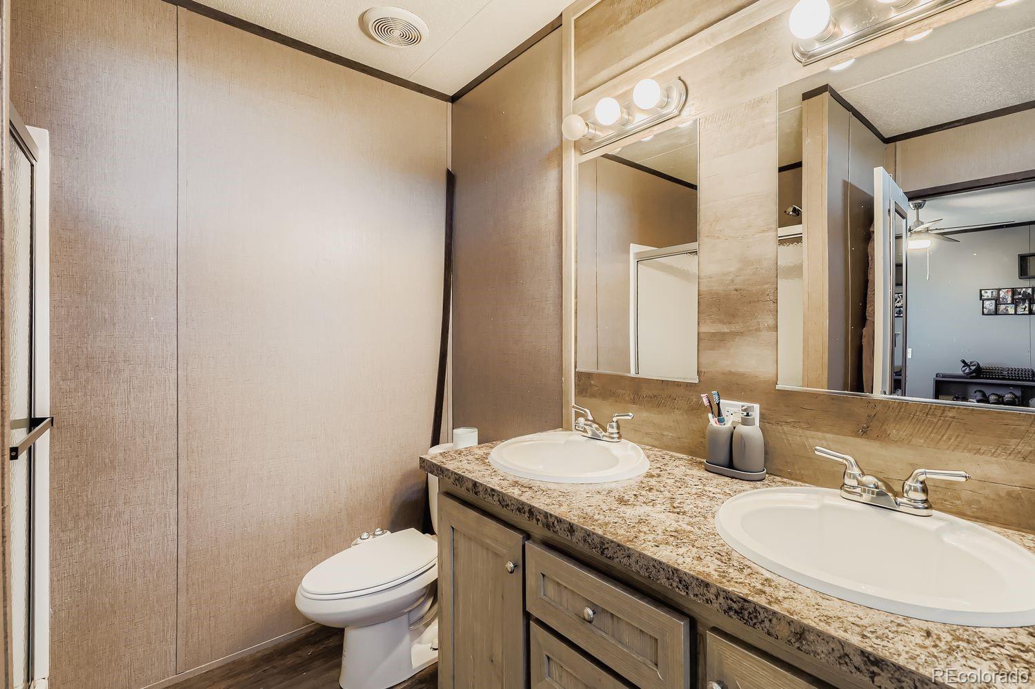 27604 Mucho Grande View Road Calhan, CO 80808 - Photo 9 of 16 a bathroom with a granite countertop sink toilet and shower