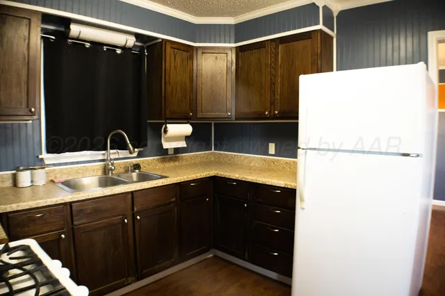 a kitchen with a sink and a refrigerator