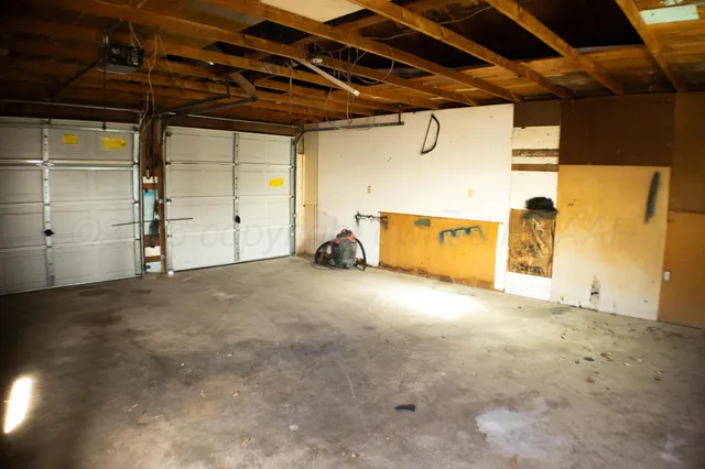 a view of a backyard with a garden and entertaining space