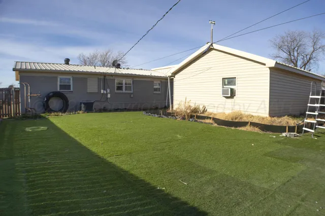 a view of the house with a yard