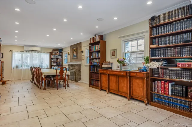 a living room with furniture and a book shelf