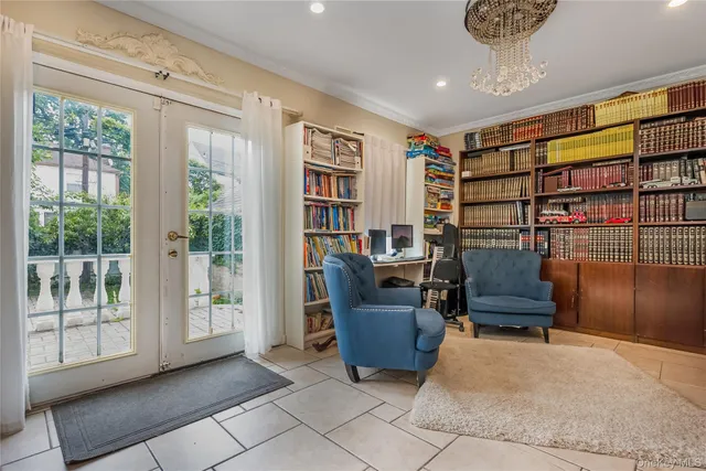 a bedroom with two beds and large window