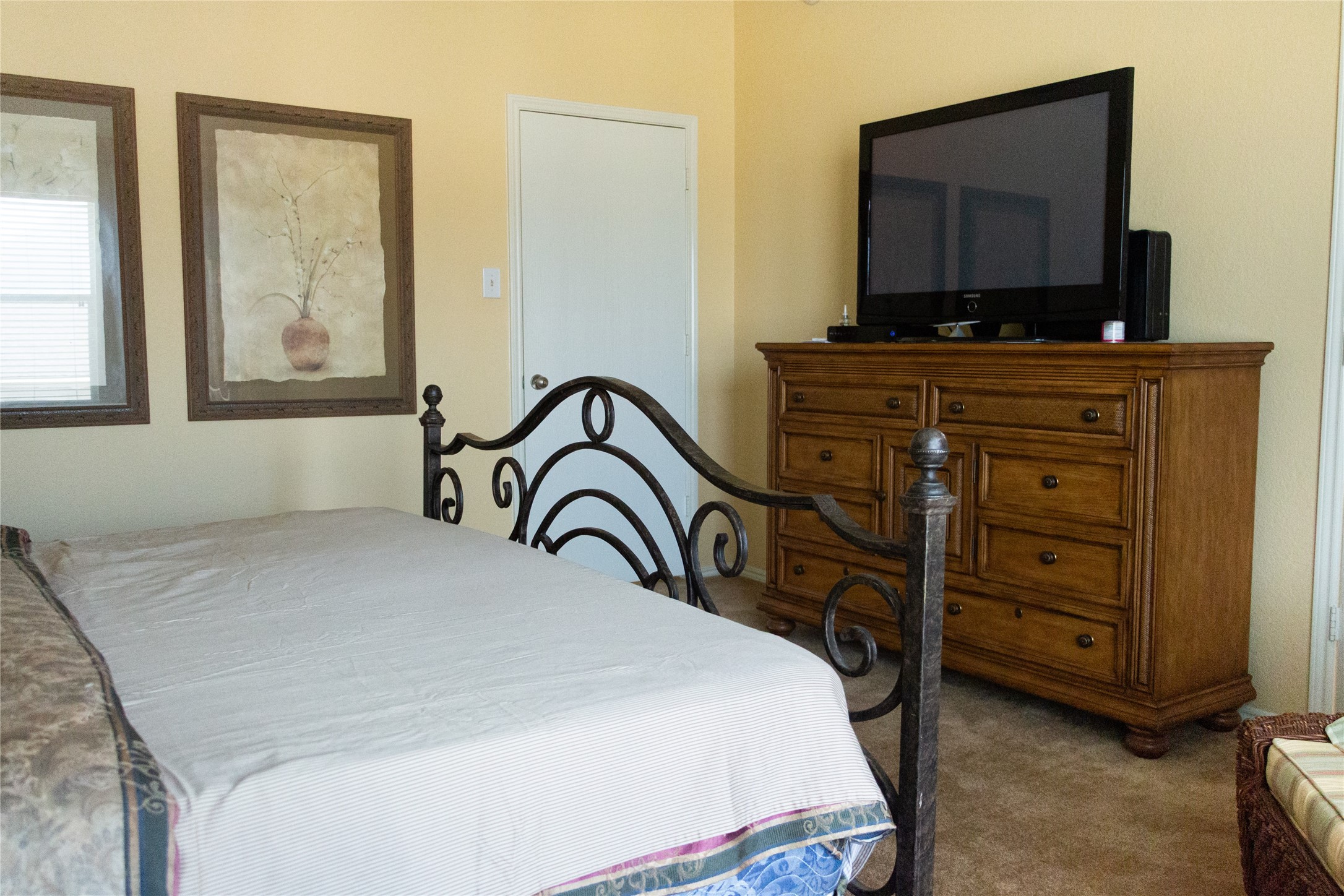 20403 Shire Ridge Lane Humble, TX 77338 - Photo 16 of 30 a bedroom with a bed and a flat tv screen on dresser