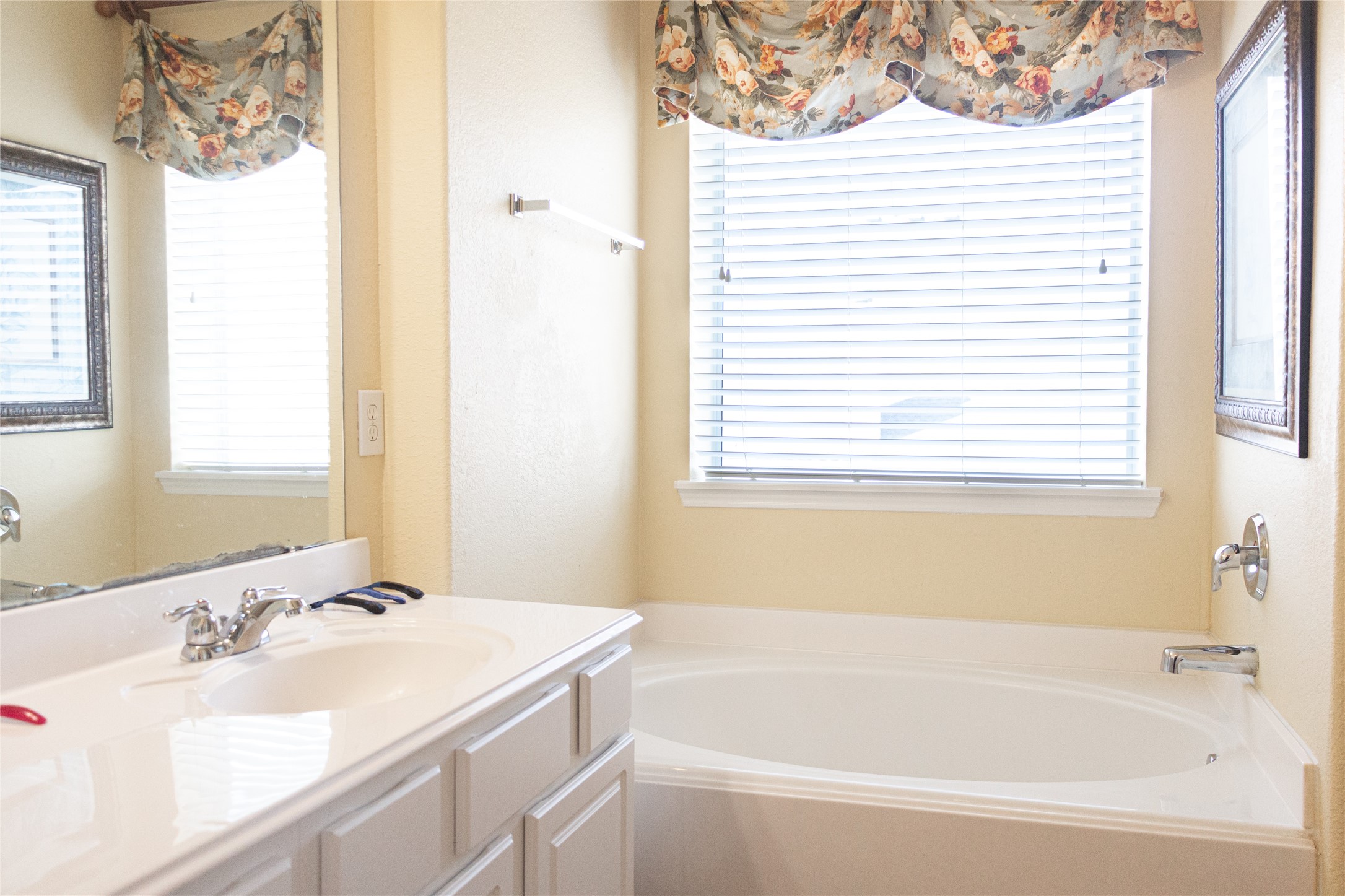 20403 Shire Ridge Lane Humble, TX 77338 - Photo 19 of 30 a bathroom with a sink vanity tub and a mirror