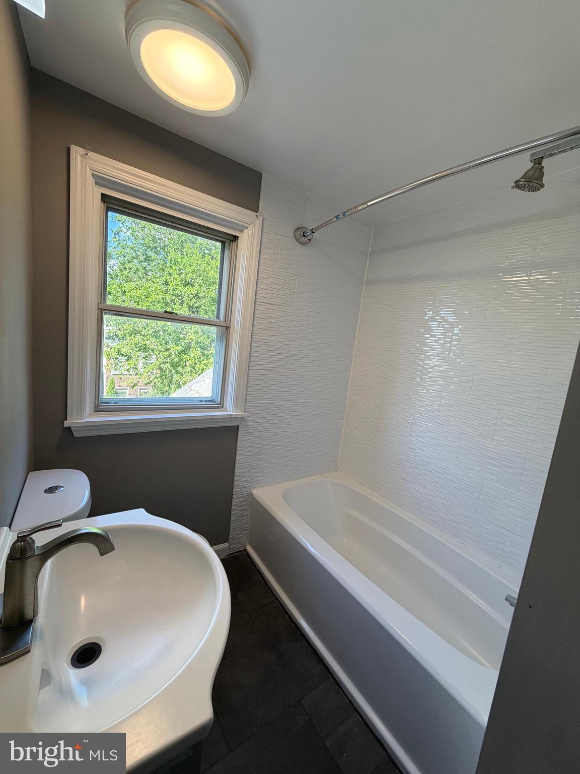1353 Cambria Street Baltimore, MD 21225 - Photo 13 of 23 a bathroom with a sink and a bathtub