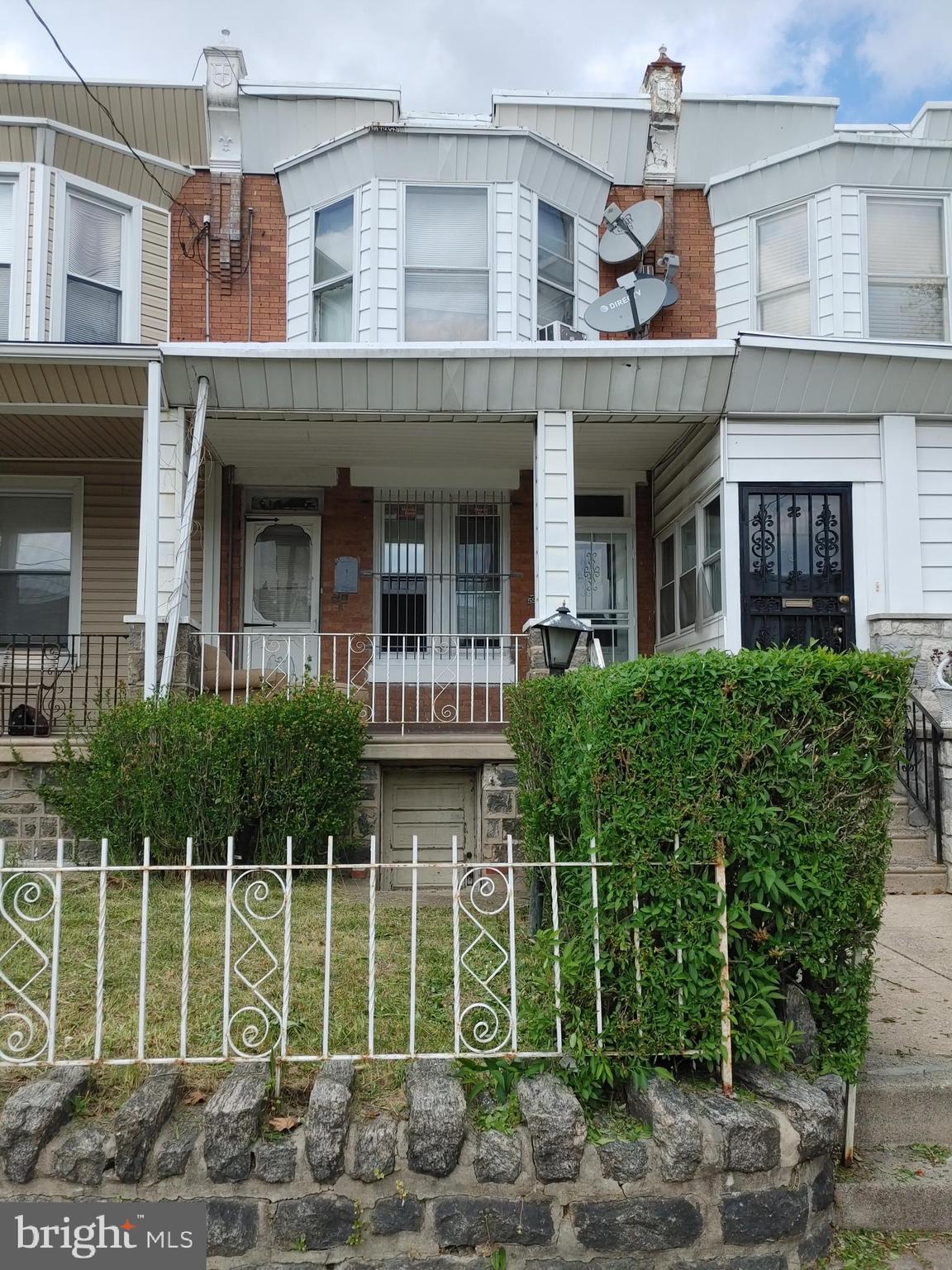 5917 Spruce Street, Unit 1 Philadelphia, PA 19139 - Photo 1 of 15 a front view of a building with plants