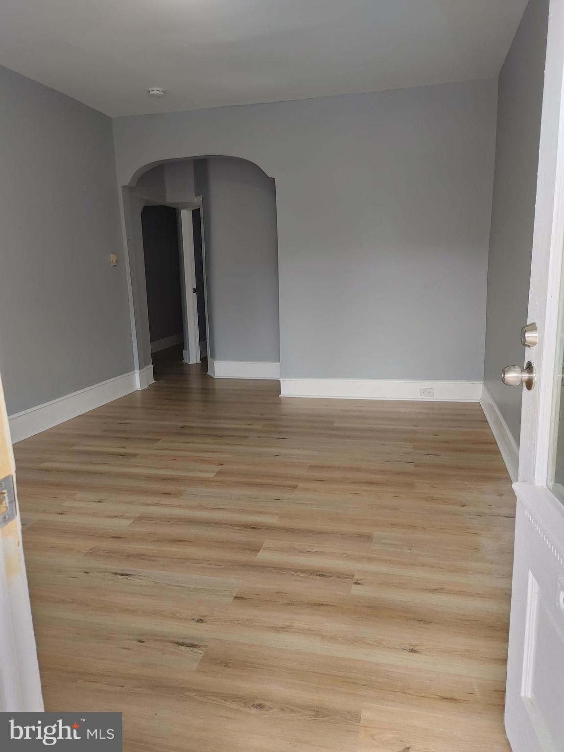 5917 Spruce Street, Unit 1 Philadelphia, PA 19139 - Photo 2 of 15 a view of an empty room with wooden floor and a window