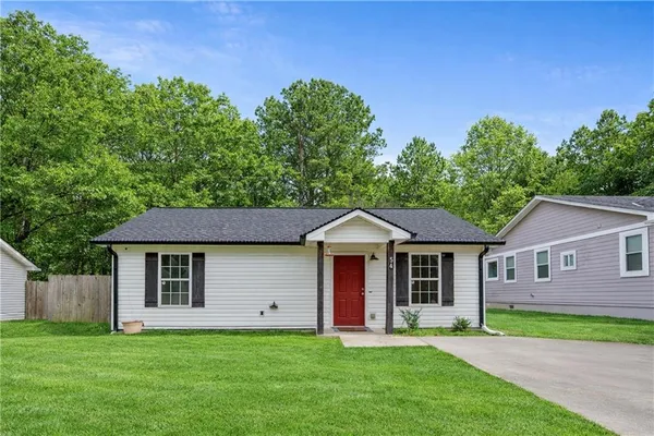 a front view of a house with a garden