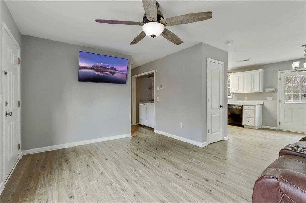 54 Taylorsville Road Aragon, GA 30104 - Photo 15 of 29 an empty room with wooden floor ceiling fan and windows