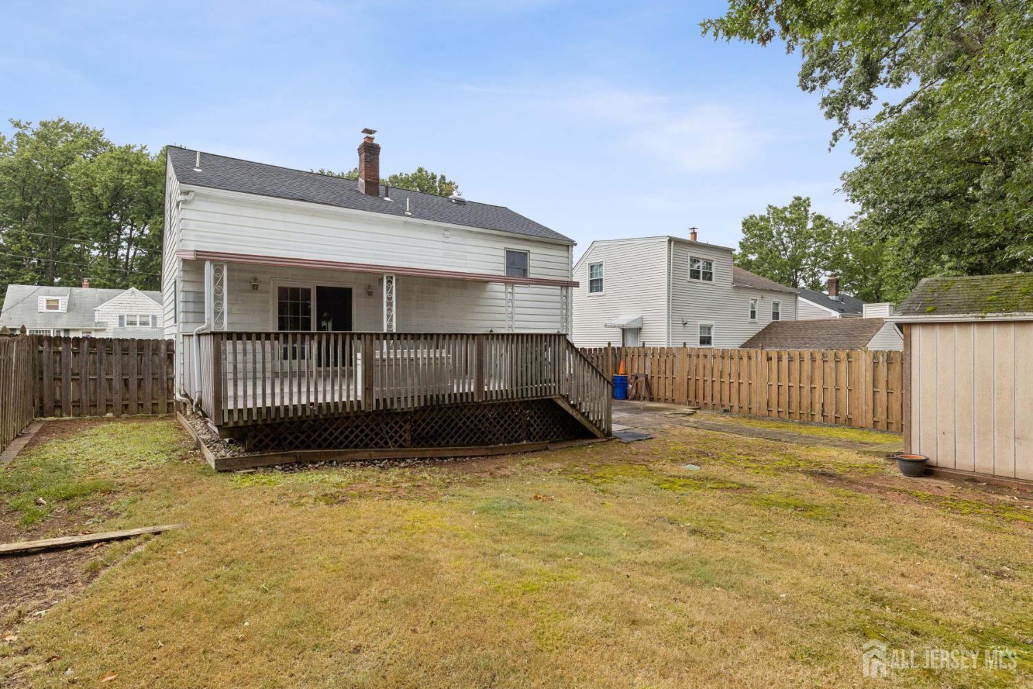 19 Overlook Terrace Fords, NJ 08863 - Photo 18 of 18 a view of backyard with small cabin and wooden fence