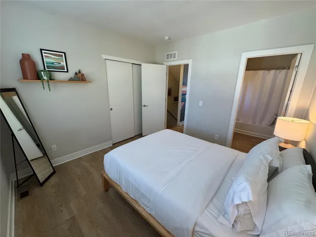a bedroom with a bed and a mirror