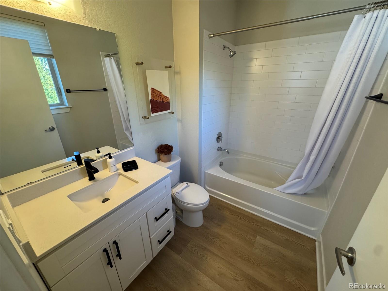 2124 Decatur Street Denver, CO 80211 - Photo 18 of 29 a bathroom with a double vanity sink toilet and shower