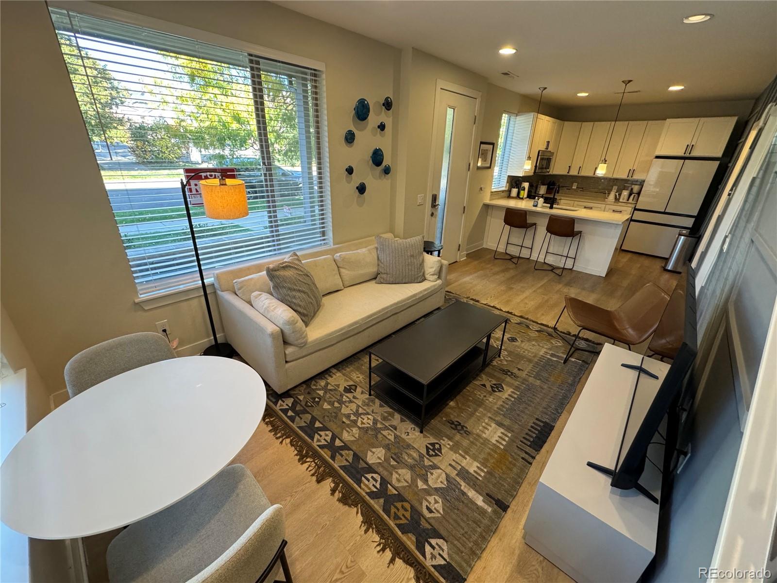 2124 Decatur Street Denver, CO 80211 - Photo 5 of 29 a living room with furniture and a large window
