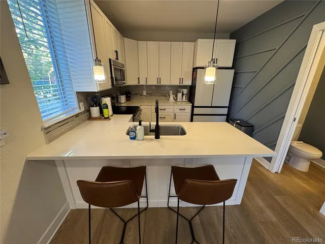 a kitchen with a table chairs and a refrigerator