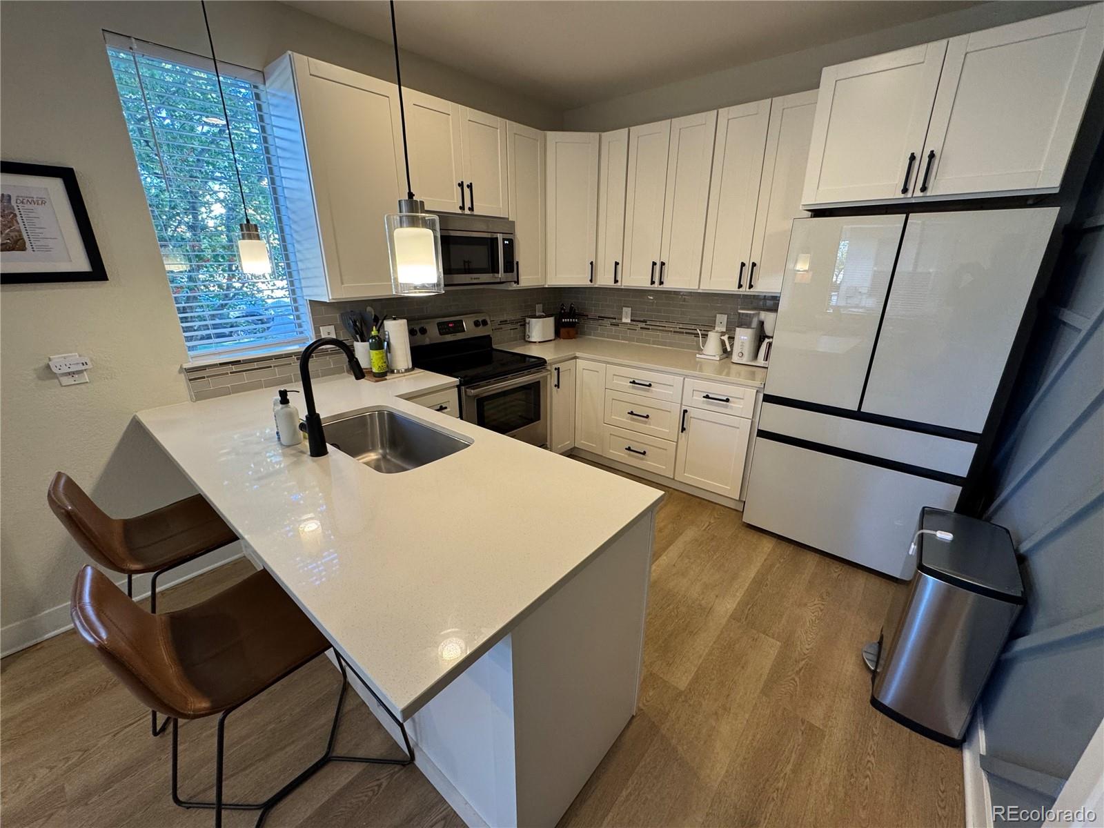 2124 Decatur Street Denver, CO 80211 - Photo 7 of 29 a kitchen with a sink appliances and cabinets