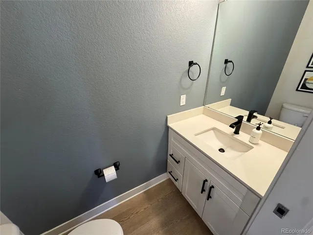a bathroom with a sink mirror and vanity