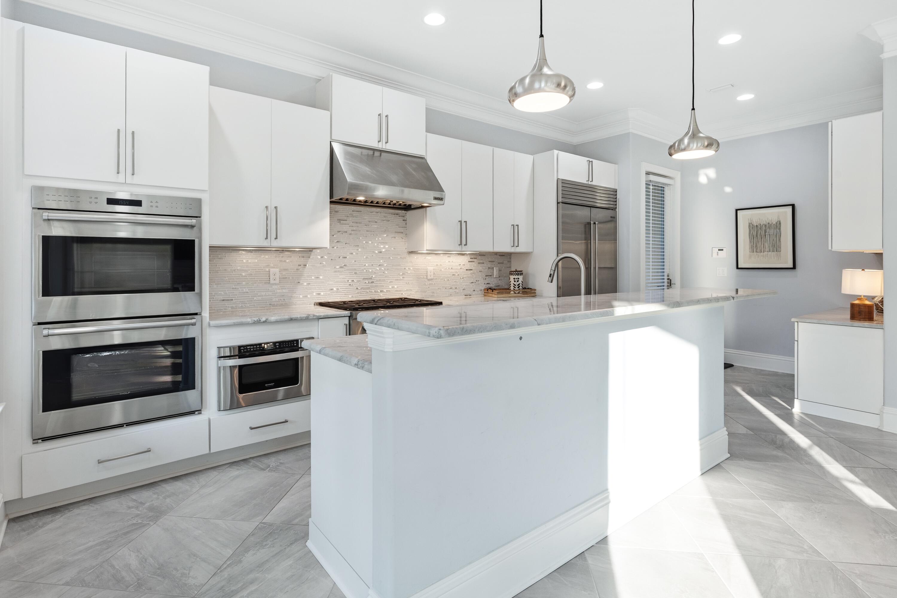 265 Rue Martine Miramar Beach, FL 32550 - Photo 14 of 82 a kitchen with kitchen island a stove a sink and a refrigerator